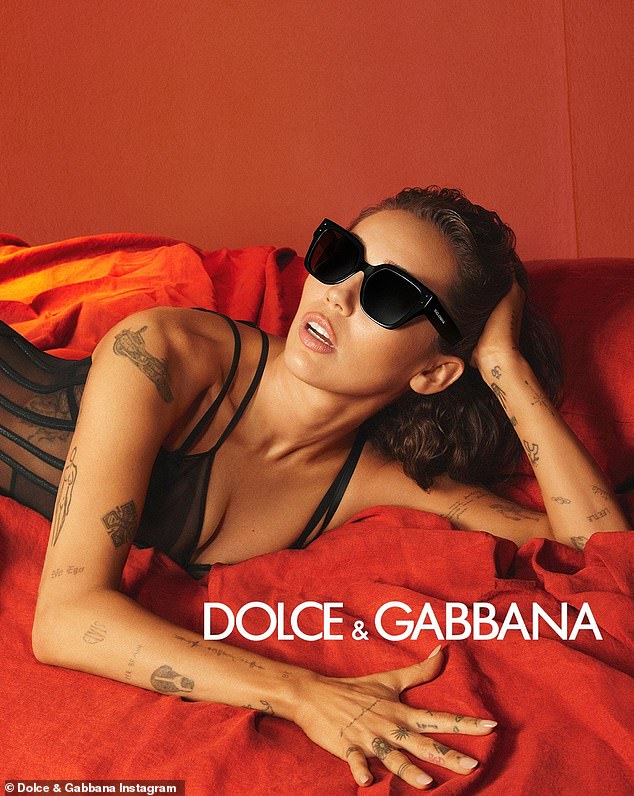 Miley Cyrus donned some chunky black shades and matching sheer lingerie in new pH๏τos from her Dolce & Gabbana eyewear campaign