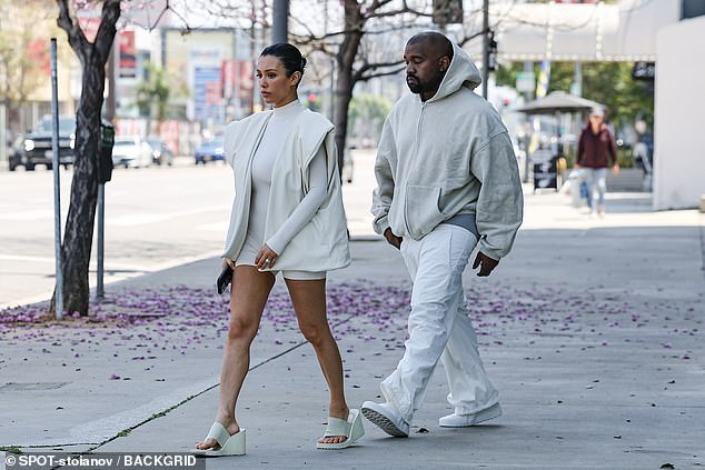 The 46-year-old rapper wore a cream hoodie, paired with baggy sweats, flashing his grey underwear as he strolled alongside his wife, 29 in LA