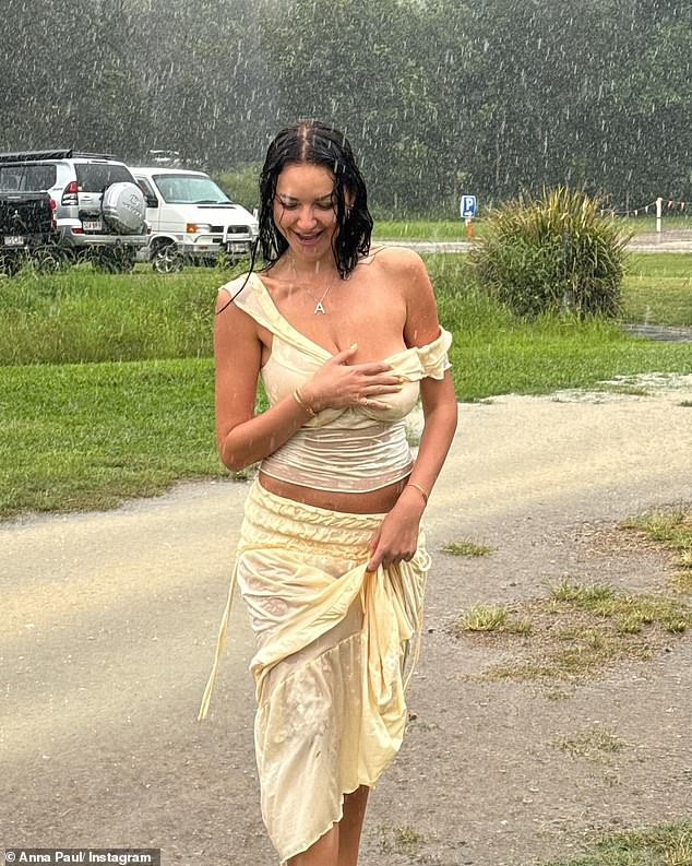 Taking to Instagram on Tuesday, Anna Paul (pictured) bared all in a daring yellow top and skirt drenched from the rain